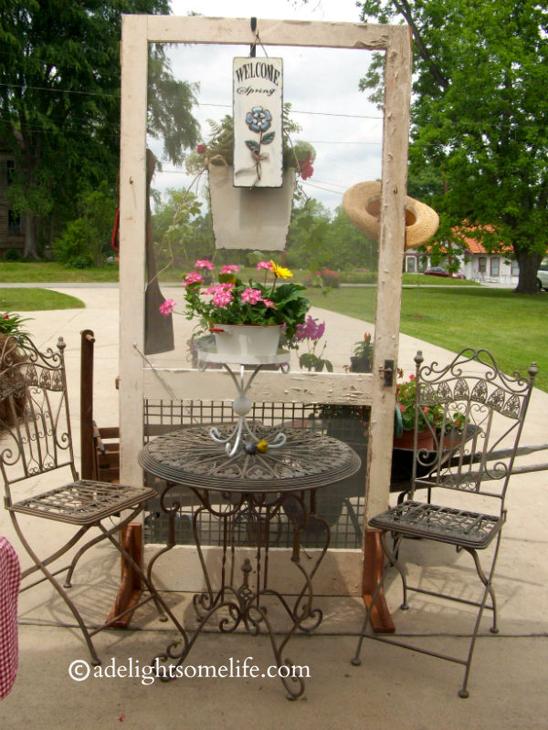 On the other side of the screen is a beautiful bistro set - she had stands filled with pans and flowers on the tables.