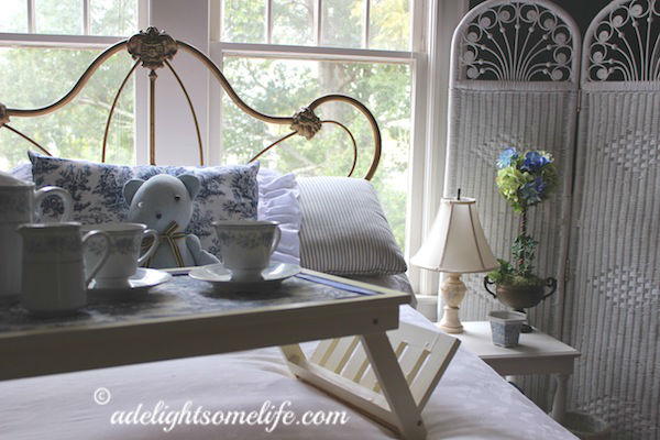 alabaster lamp, topiary hydrangea, cast iron bed, bed tray, blue and white china