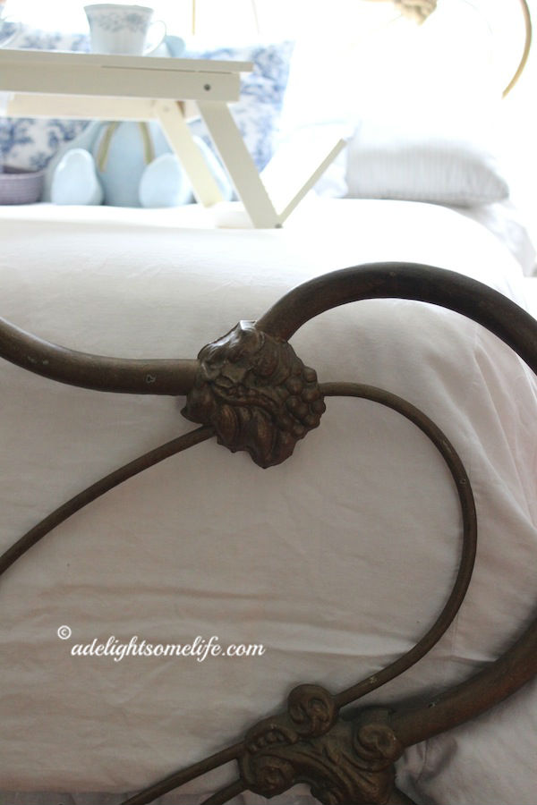 down comforter, white duvet, cast iron bed detail, full size bed