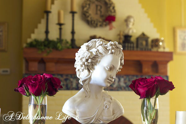 red roses and ladies view to mantel vignette