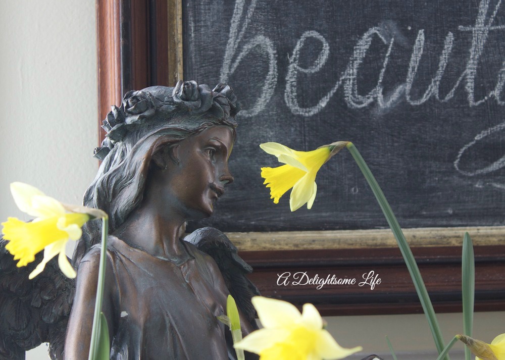 garden statue daffodils and chalkboard art