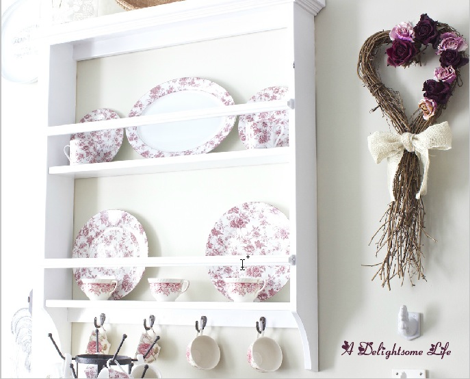 A DELIGHTSOME LIFE rustic wreath with dried roses plate rack with red chintz china