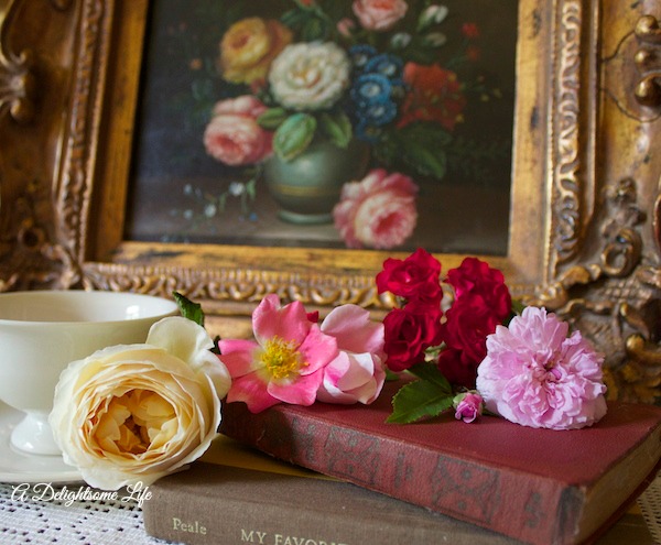 A DELIGHTSOME LIFE LIFE IS BEAUTIFUL YELLOW ROSE OLD BOOKS WHITE TEACUP ROSE PAINTING