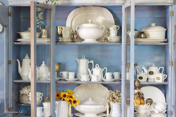 White Tea Set with white dishes in blue china cabinet. A Delightsome Life