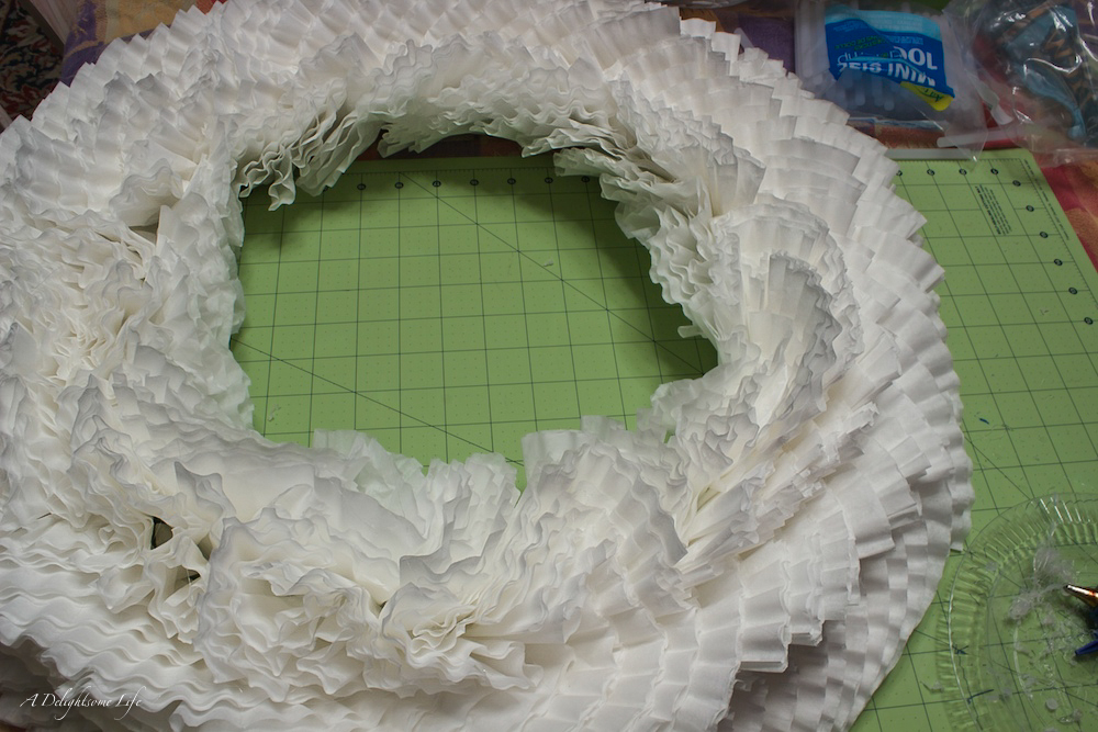 in this method, the folded filters are glued facing the same direction going round the form at each ring.