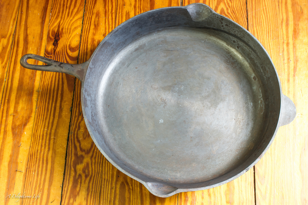 once cleaned, the pan is brought back to the gun metal gray color of new cast iron pans-Cast Iron Pans Reseasoned-how to restore, reseason and maintain cast iron