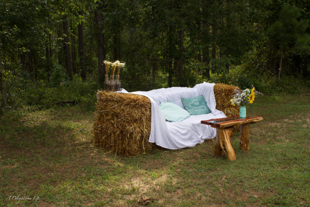 my daughter wanted this wonderful hay bale couch for the guests to enjoy at her wedding in a sunflower field