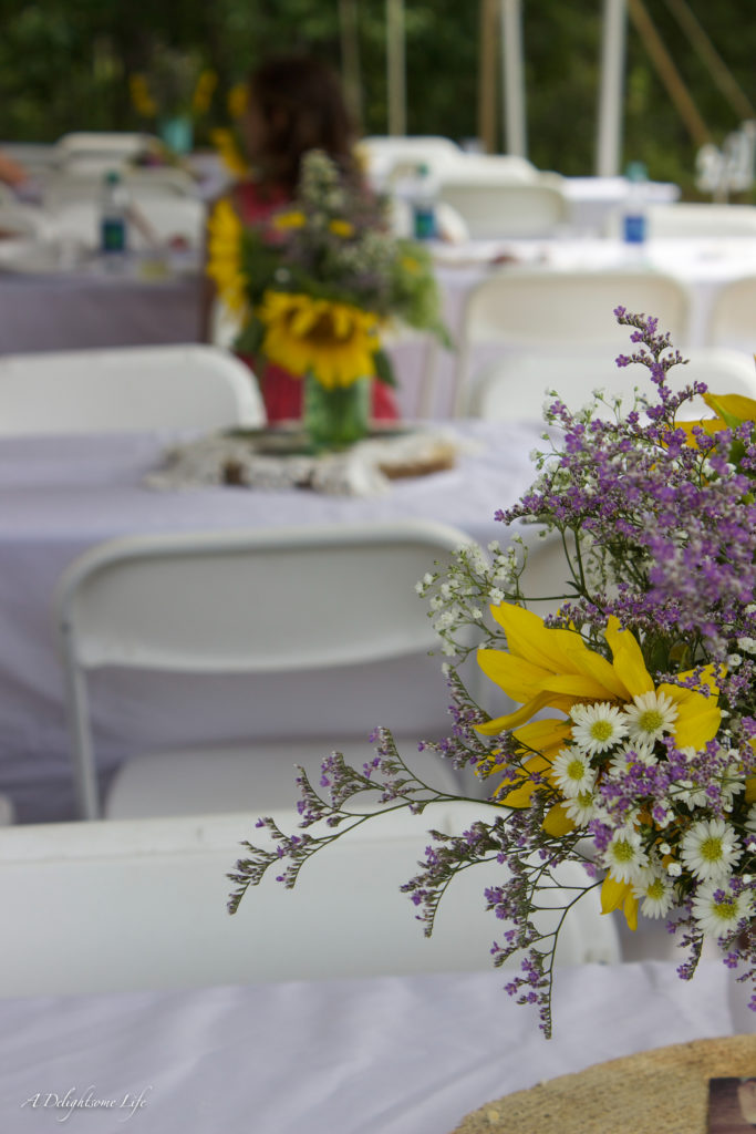 Wedding in Sunflower field: the flower arrangements of sunflowers, baby's breath, purple misty created colorful, airy arrangements for my daughter's wedding in a sunflower field