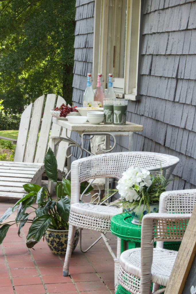 Updating front porch for summer by painting furniture bright green and white