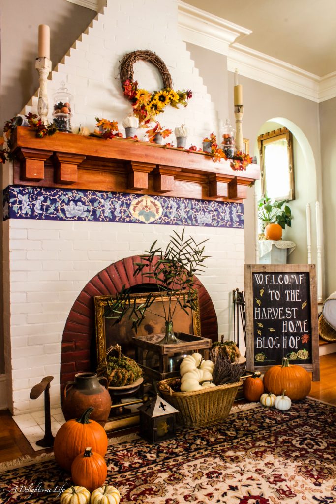 The fireplace is ablaze with autumnal colors and a welcome to the Fall Harvest Home tour on A Delightsome Life