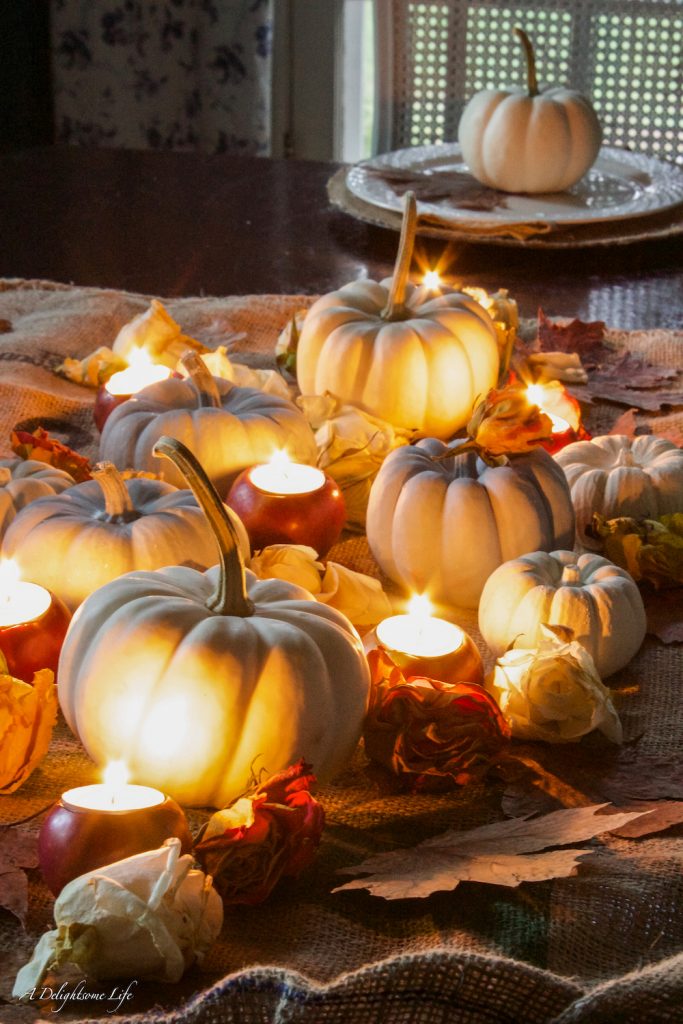 Romantic Fall tablescape with pumpkins, apple votives and dried roses on A Delightsome Life