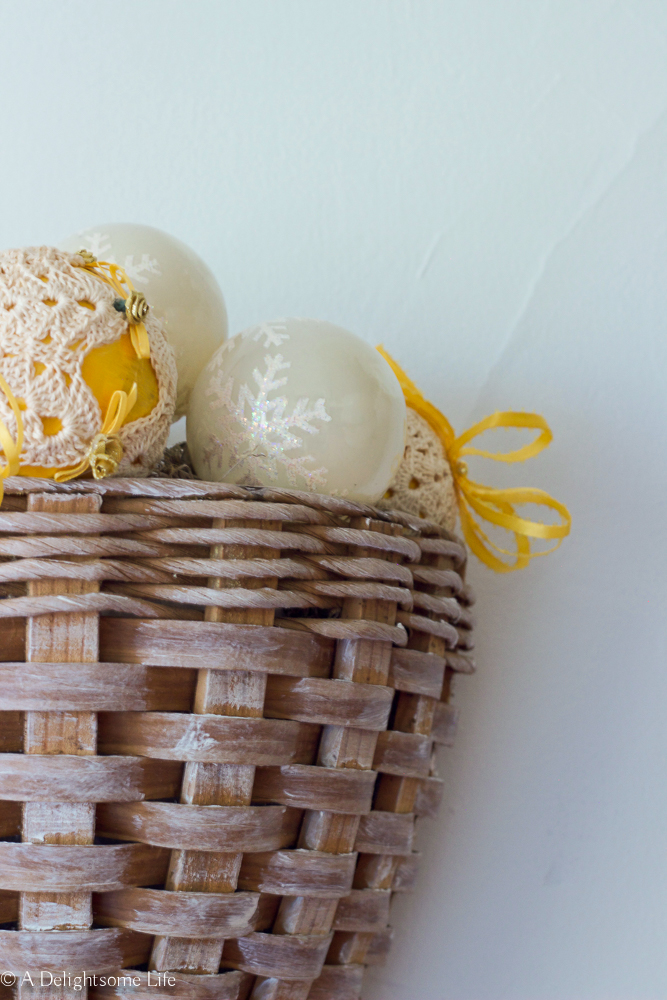 simple Christmas ball ornaments added to white-washed basket on A Delightsome Life
