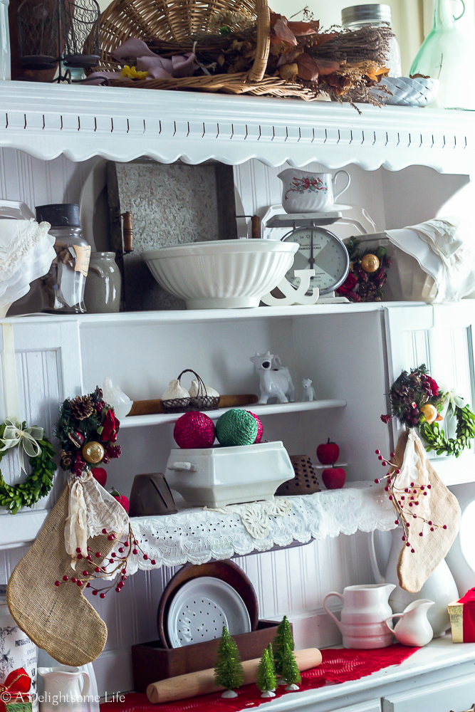 collectibles on kitchen hutch decorated in French Farmhouse style for Christmas