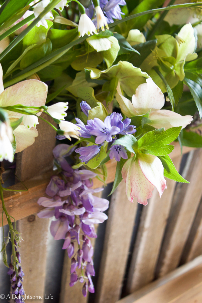 Spring blue and green flowers in a Rustic Planter