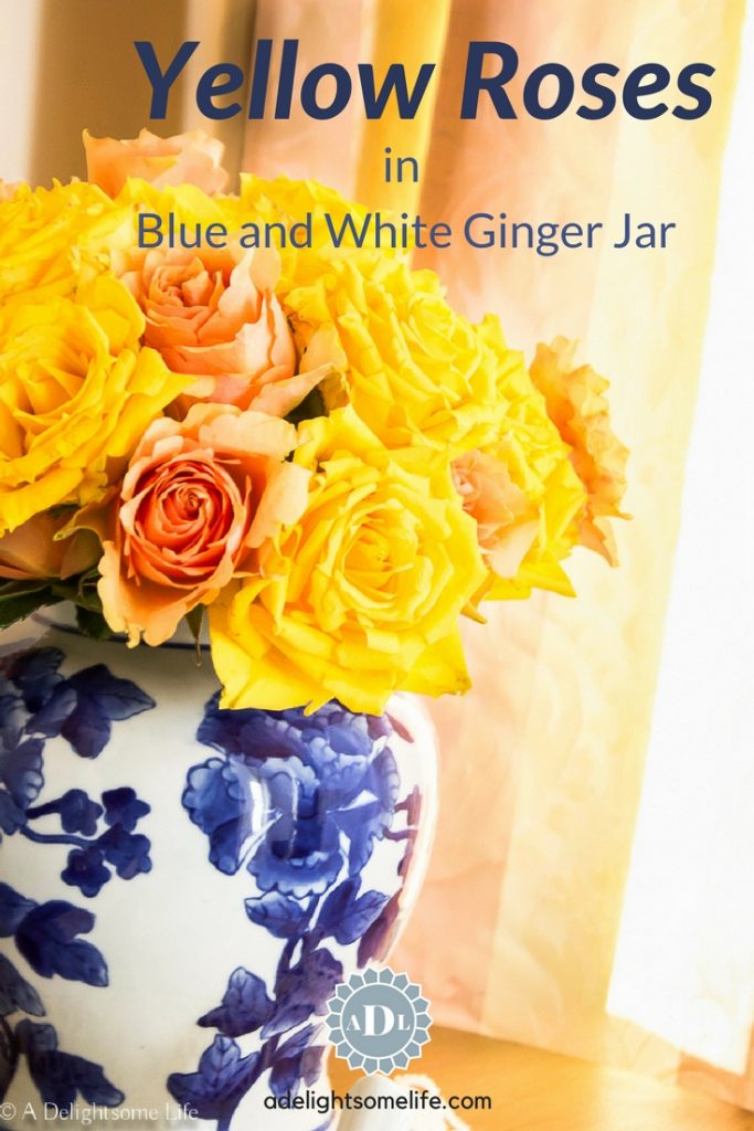 yellow roses in blue and white jar